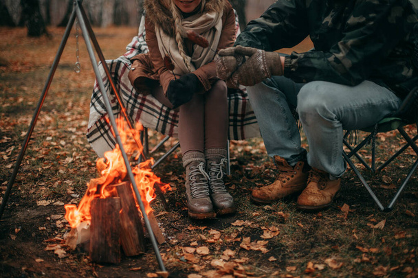 Couple in love in autumn on a camping near a bonfire - 写真・画像