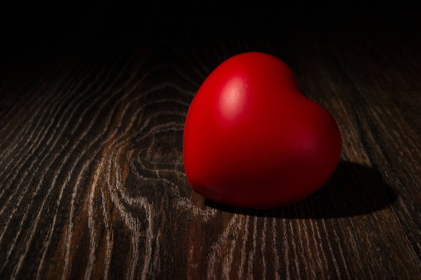 One large red heart on wooden background close up - Foto, immagini