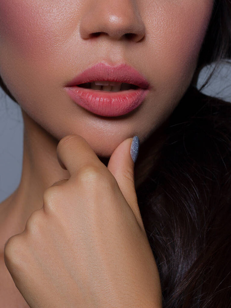 Cosmetics, makeup and trends. Bright lip gloss and lipstick on lips. Closeup of beautiful female mouth with natural lip makeup. Beautiful part of female face. Perfect clean skin in natural light - Photo, Image