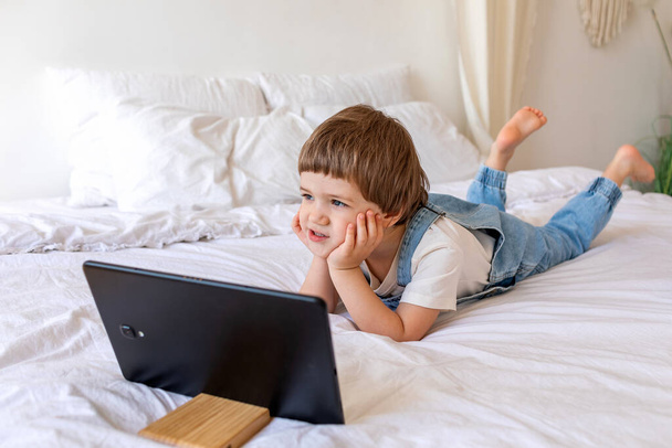 preschool caucasian child has video call on his tablet pc - Foto, Imagen