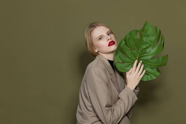 fashionable woman red lips palm leaf charm fashion Lifestyle posing - Foto, imagen