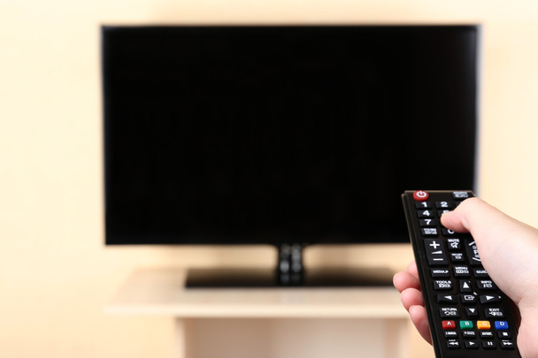 TV and using remote controller - Φωτογραφία, εικόνα