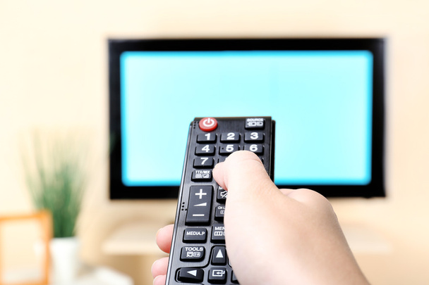 TV and using remote controller - Φωτογραφία, εικόνα