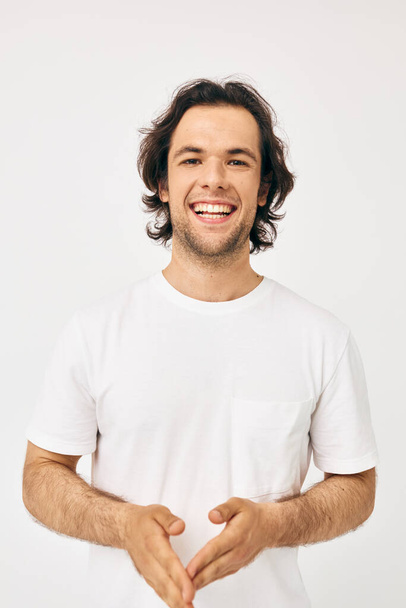 Attractive man in white t-shirt fashion cropped view isolated background - Foto, afbeelding
