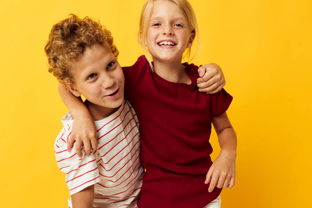 Cute preschool kids cuddling fashion childhood entertainment on colored background - Фото, изображение