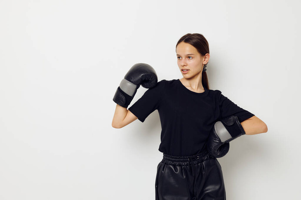 beautiful girl in black sports uniform boxing gloves posing Lifestyle unaltered - Photo, Image