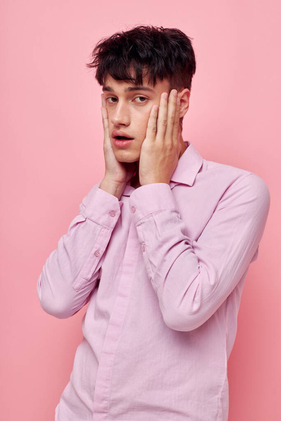 portrait of a young man posing fashion pink shirt modern style isolated background unaltered - Фото, изображение