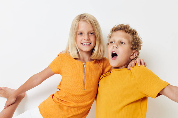 Boy and girl casual wear games fun together posing emotions quarrel isolated background unaltered - Фото, зображення