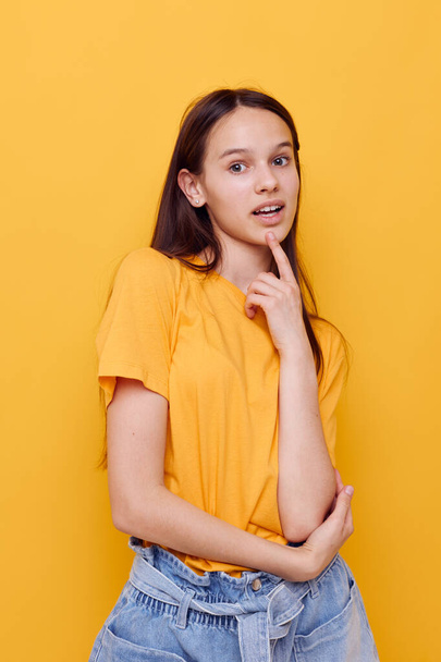attractive woman in a yellow t-shirt emotions summer style isolated background - Фото, изображение