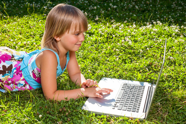Child with computer outdoor  - Foto, imagen