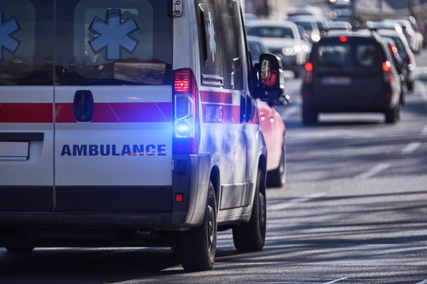 Paramedic 911 ambulance car running fast through the big city. - Valokuva, kuva
