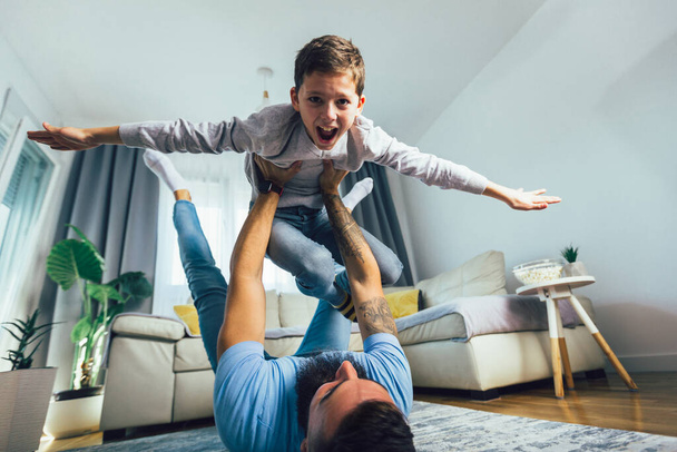 Father and son having fun at home. - Fotografie, Obrázek