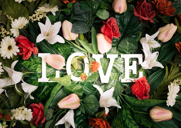 Colorful love background. Floral Greeting card. Happy Women's Day. Spring flower flat lay holiday background with word Love. Nature Trendy Design. Happy Valentine's Day. - Фото, изображение
