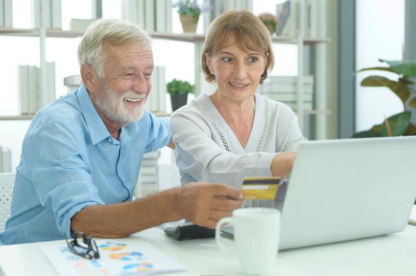 Caucasian senior people holding credit card, shopping online concept - 写真・画像
