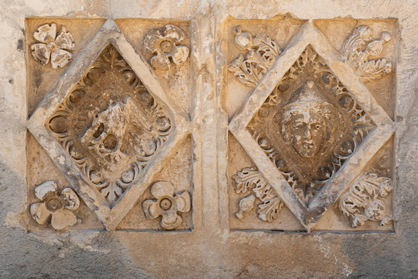 half-erased stone-cut reliefs on the ruins of a building in the ancient city of Myra, Turkey - 写真・画像