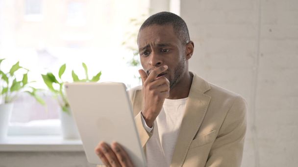 Portrait of African Man having Loss on Tablet in Office - Photo, Image