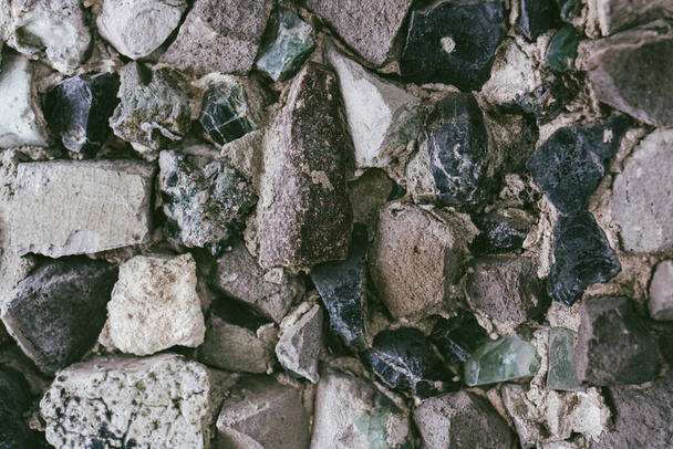 Part of old stone wall for background. Rocks of different sizes and forms. Cobble texture close up - Foto, immagini