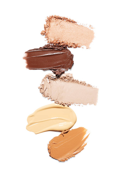 Tone foundation smears, eye shadow, concealer and highlighter isolated on white background. Cosmetic set - Foto, Imagem
