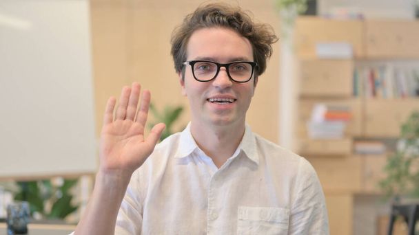 Young Man Waving for Online Video Call - Фото, изображение
