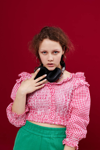 cheerful girl with headphones in a pink blouse music technology red background - Fotoğraf, Görsel