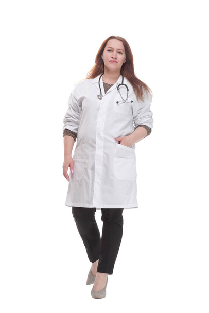 mature woman doctor striding forward. isolated on a white background. - 写真・画像