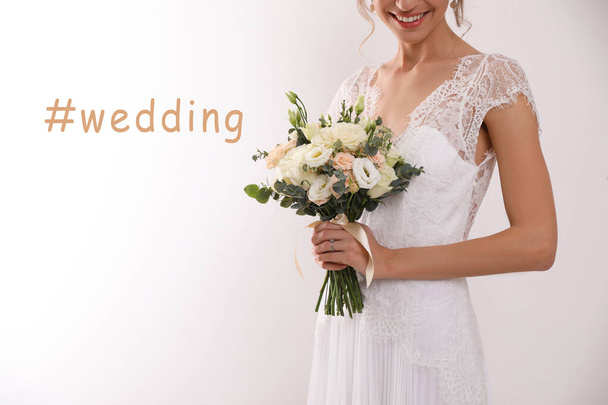 Hashtag Wedding and young bride with beautiful bouquet on white background, closeup  - Φωτογραφία, εικόνα