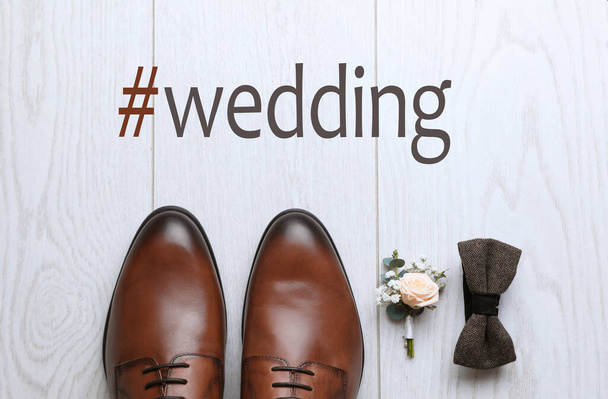 Flat lay composition with shoes and hashtag Wedding on white wooden background - Valokuva, kuva