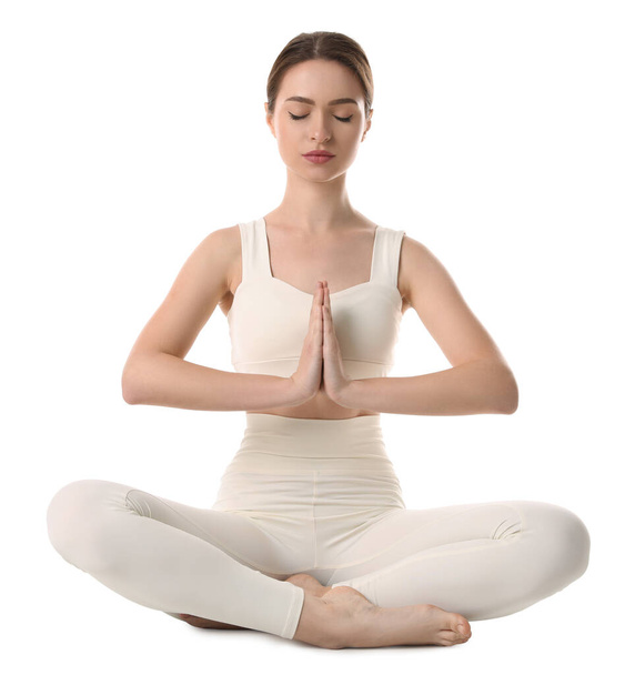 Beautiful young woman meditating on white background - 写真・画像