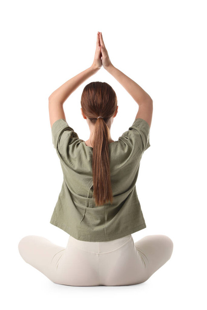 Young woman meditating on white background, back view - Фото, изображение