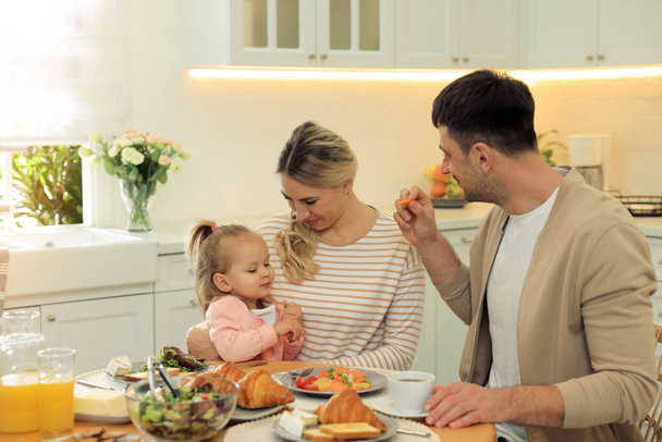 Happy family having breakfast together at table in kitchen - Photo, Image