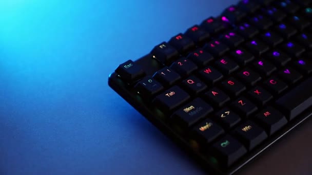 Mechanical keyboard on desk with blue lighting - Footage, Video