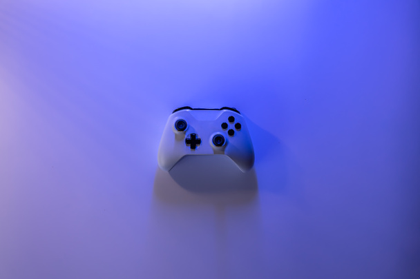 A gamepad on a blue background, copy space. - Photo, Image