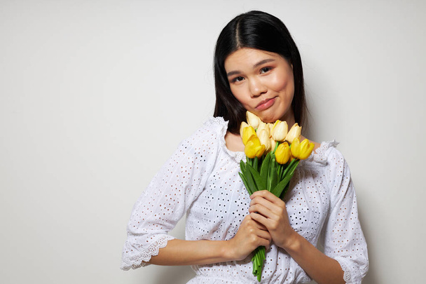 Charming young Asian woman in a white shirt flowers spring posing Lifestyle unaltered - Zdjęcie, obraz