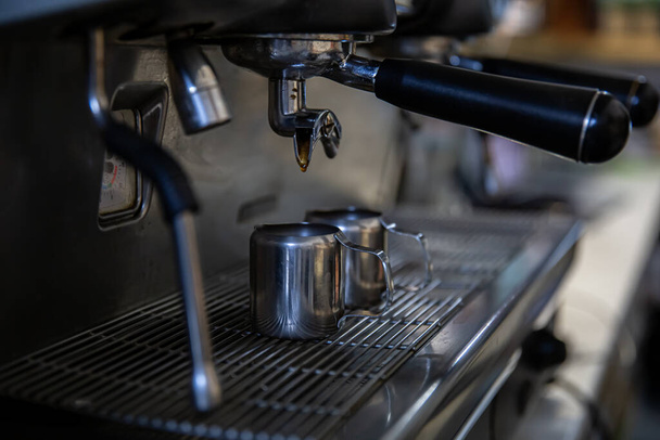 Close up of the process of making espresso in a professional coffee machine. - Photo, Image