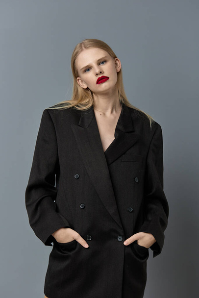 glamorous woman hand gesture black jacket makeup studio model unaltered - Foto, imagen