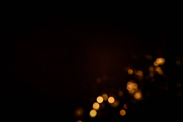 Gold abstract bokeh on black background - Photo, Image
