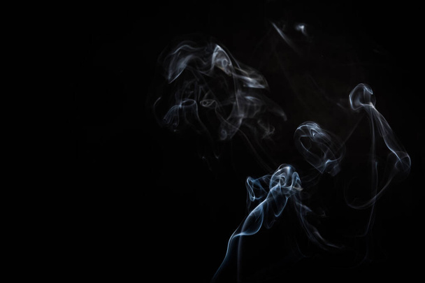 Abstract smoke swirls on black background - Fotoğraf, Görsel