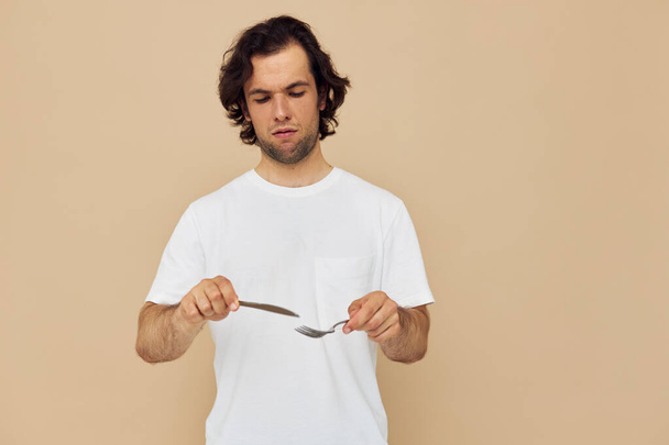 Cheerful man cutlery in hand posing isolated background - Foto, immagini
