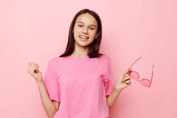 optimistic young woman in a pink t-shirt casual clothes Lifestyle unaltered - Fotó, kép