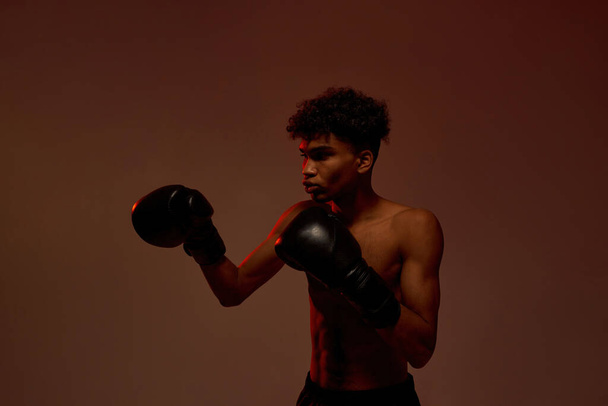 Black young male boxer boxing during training - Zdjęcie, obraz