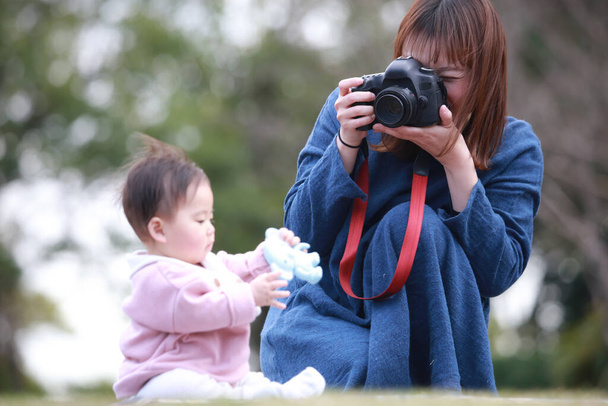 Mother taking pictures of baby  - Fotó, kép