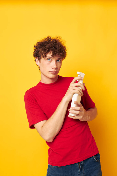 cute red-haired guy detergents home care posing isolated background unaltered - Fotó, kép