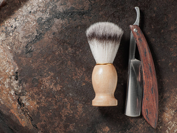 vintage barber tools. dangerous razor manual shaving brush. rusty background. top view flat lay - Foto, imagen