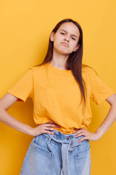 young woman in a yellow t-shirt emotions summer style isolated background - Fotó, kép