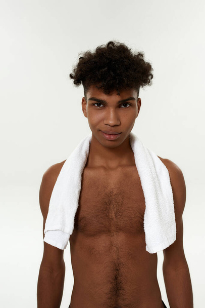 Black smiling sportsman with towel look at camera - Photo, Image