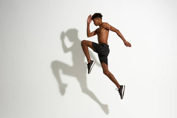Side view of sportsman jump during sport training - Foto, Imagem