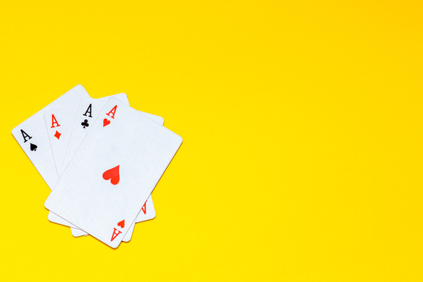 A fan of playing cards consisting of four Ace Isolated on yellow - Foto, Bild