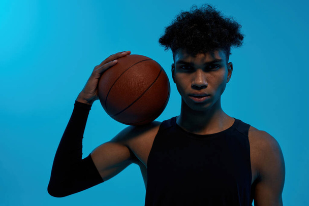 Black confident sports man holding basketball ball - Fotó, kép