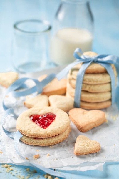 Sweet valentine cookies made of jam and milk. Shortbread for valentine day in the shape of heart with jam. - 写真・画像