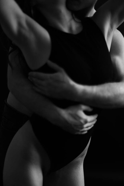 Sensual touches between a man and a woman, a beautiful fashion portrait of a couple, body details with a slight element of eroticism. A place for text and a blurred fleur of love - Fotoğraf, Görsel